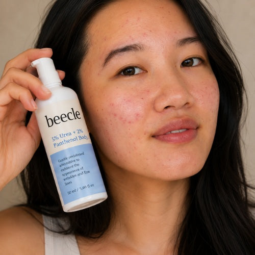 Woman holding a bottle of becele product near her face